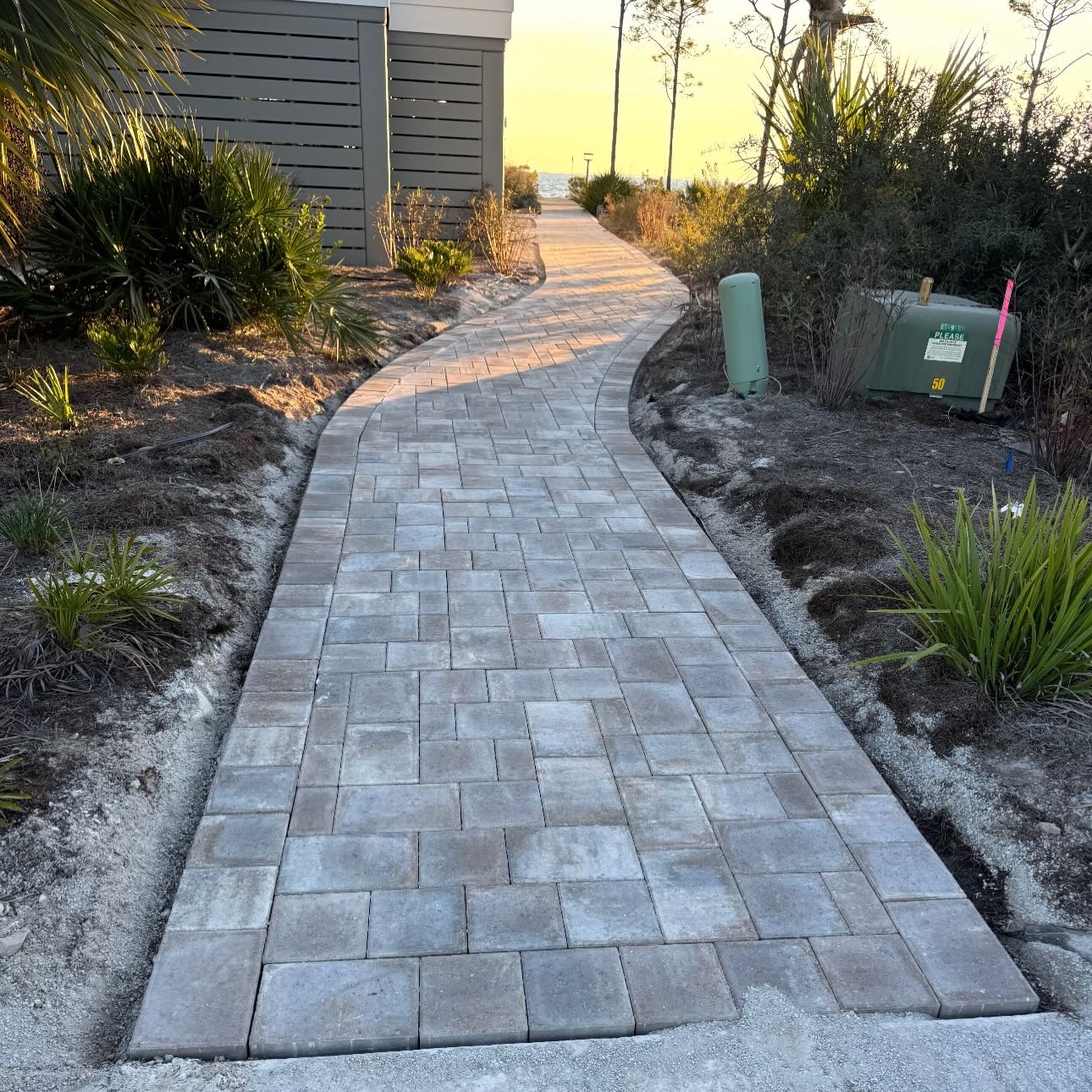 Curved paver walkway leading to the Gulf