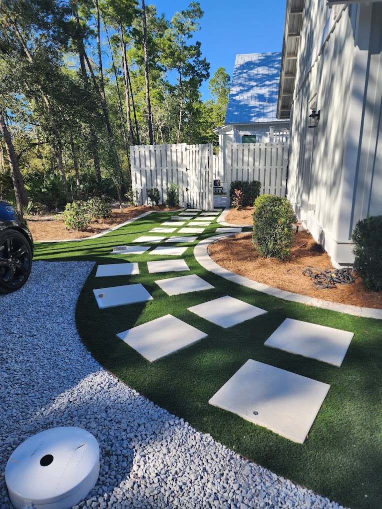 Custom turf and stepping-stone path beside a coastal home